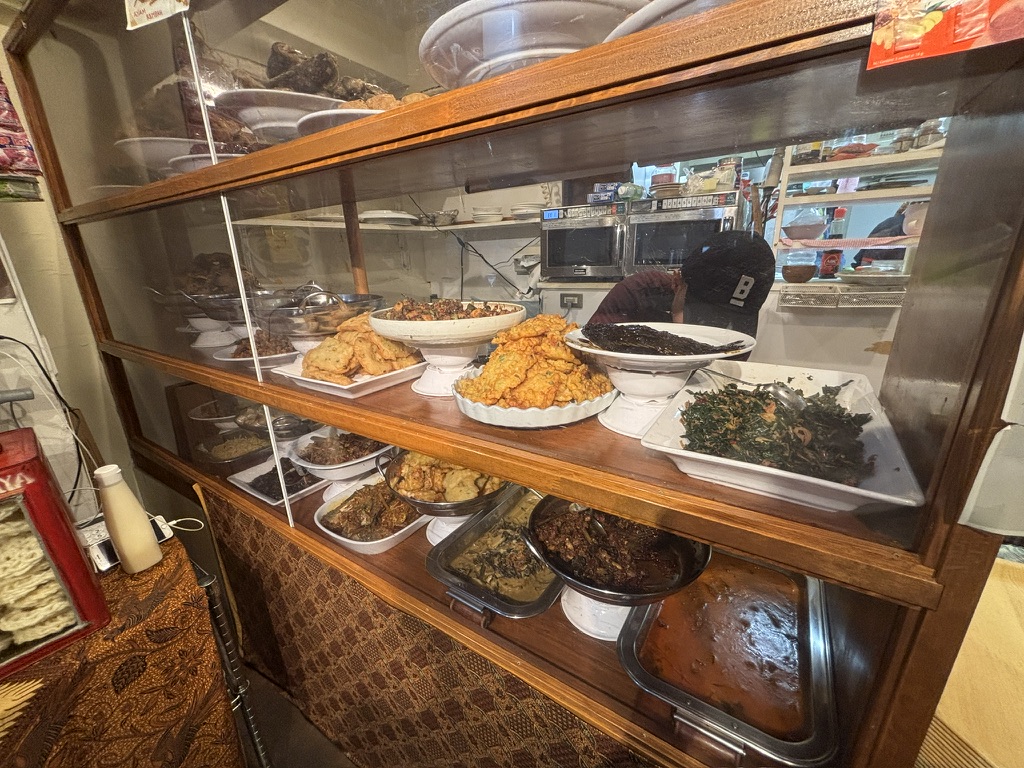 インドネシア惣菜が並ぶショーケースを横から見た様子（MONGGO MORO・新宿三丁目）