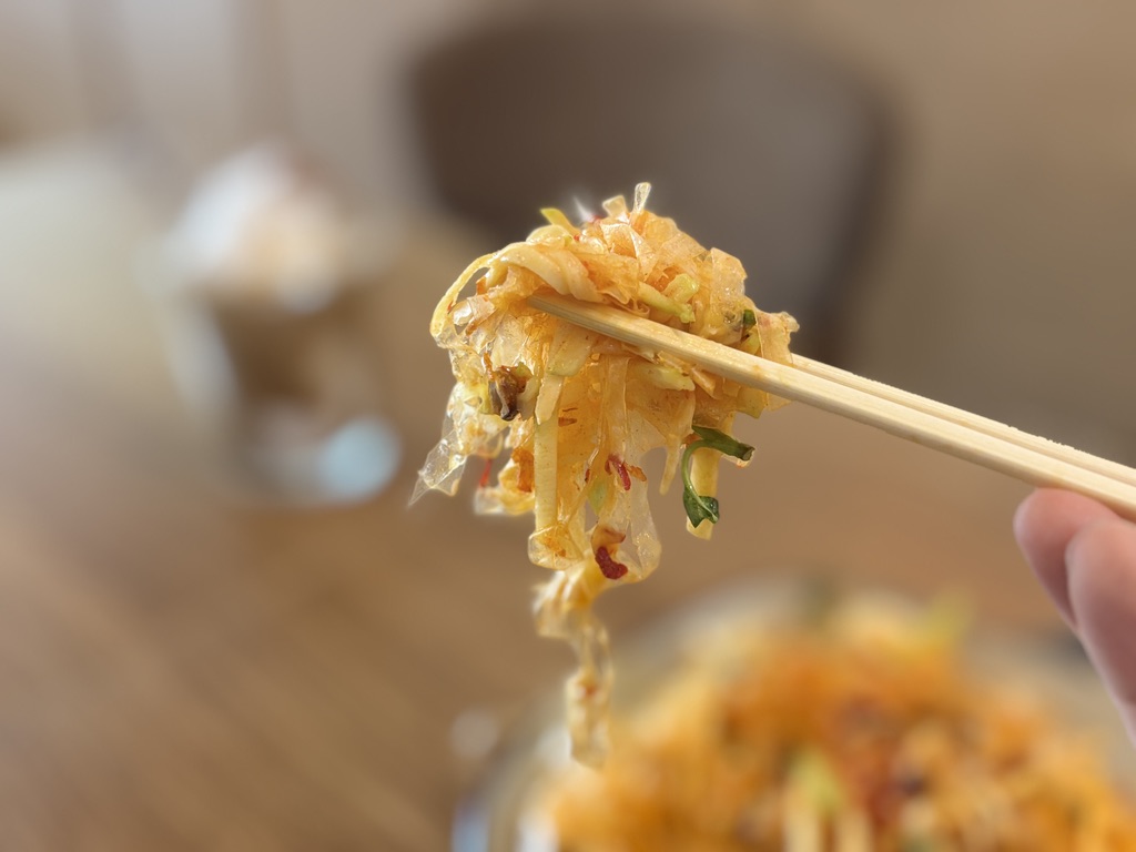 箸でつまんだバインチャントン。ふわっと絡まる千切りライスペーパーの食感